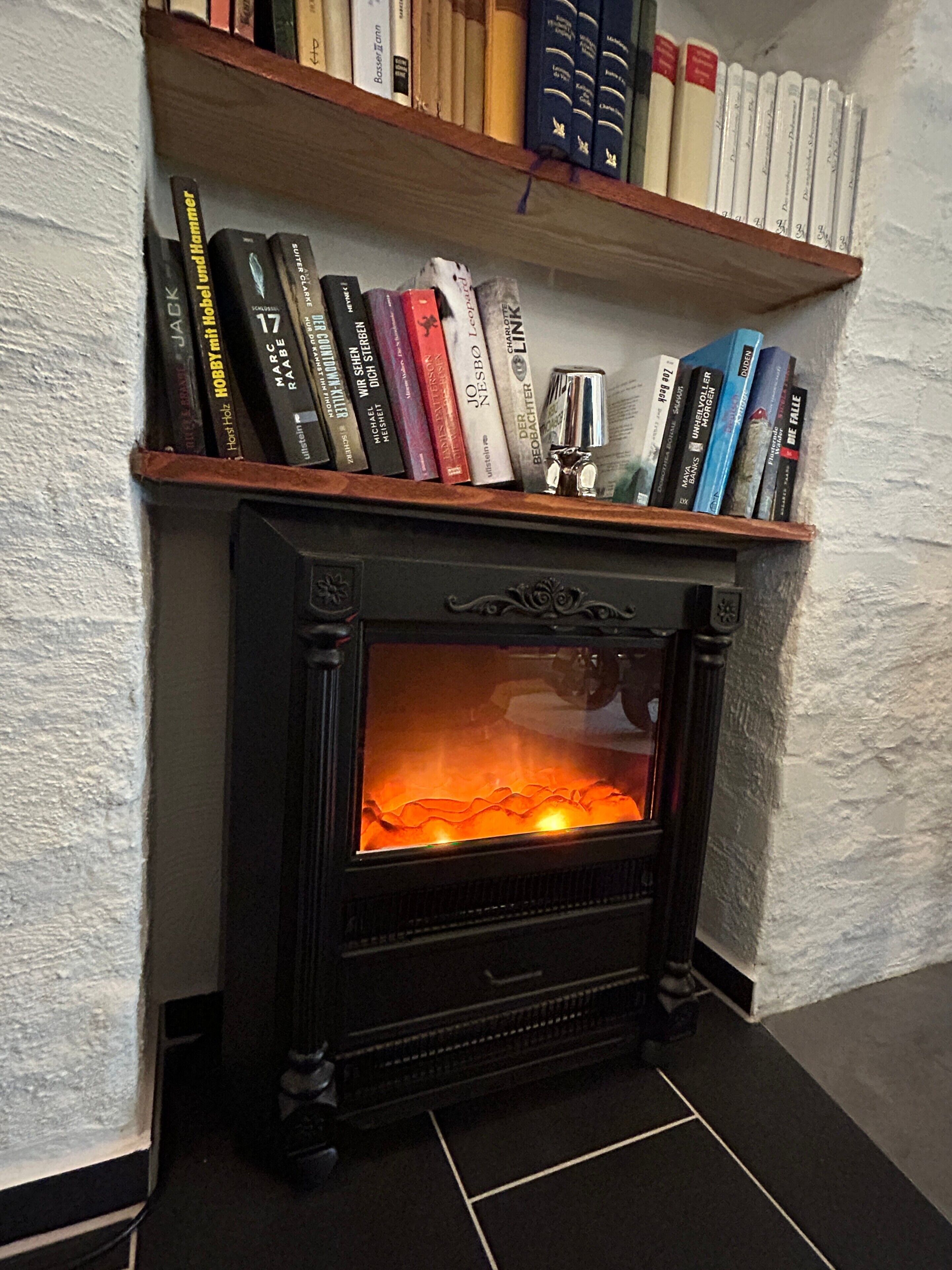 A fireplace with bookshelves above it.