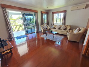 Premier Apartment | Living area | 40-inch flat-screen TV with cable channels, streaming services - Axis Apartments (Suva)