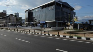 A modern building with a sign for 'Dream Motel' and a restaurant. - Dreamotel Luxury Suites and Rooms (Palakkad)