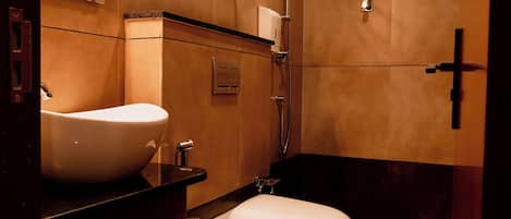A bathroom with a white toilet, a sink, and a shower.