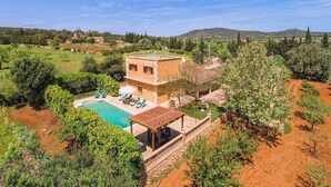 A villa with a swimming pool, surrounded by trees and hills. - Villa in Manacor with Pool and Tennis Court (Manacor)