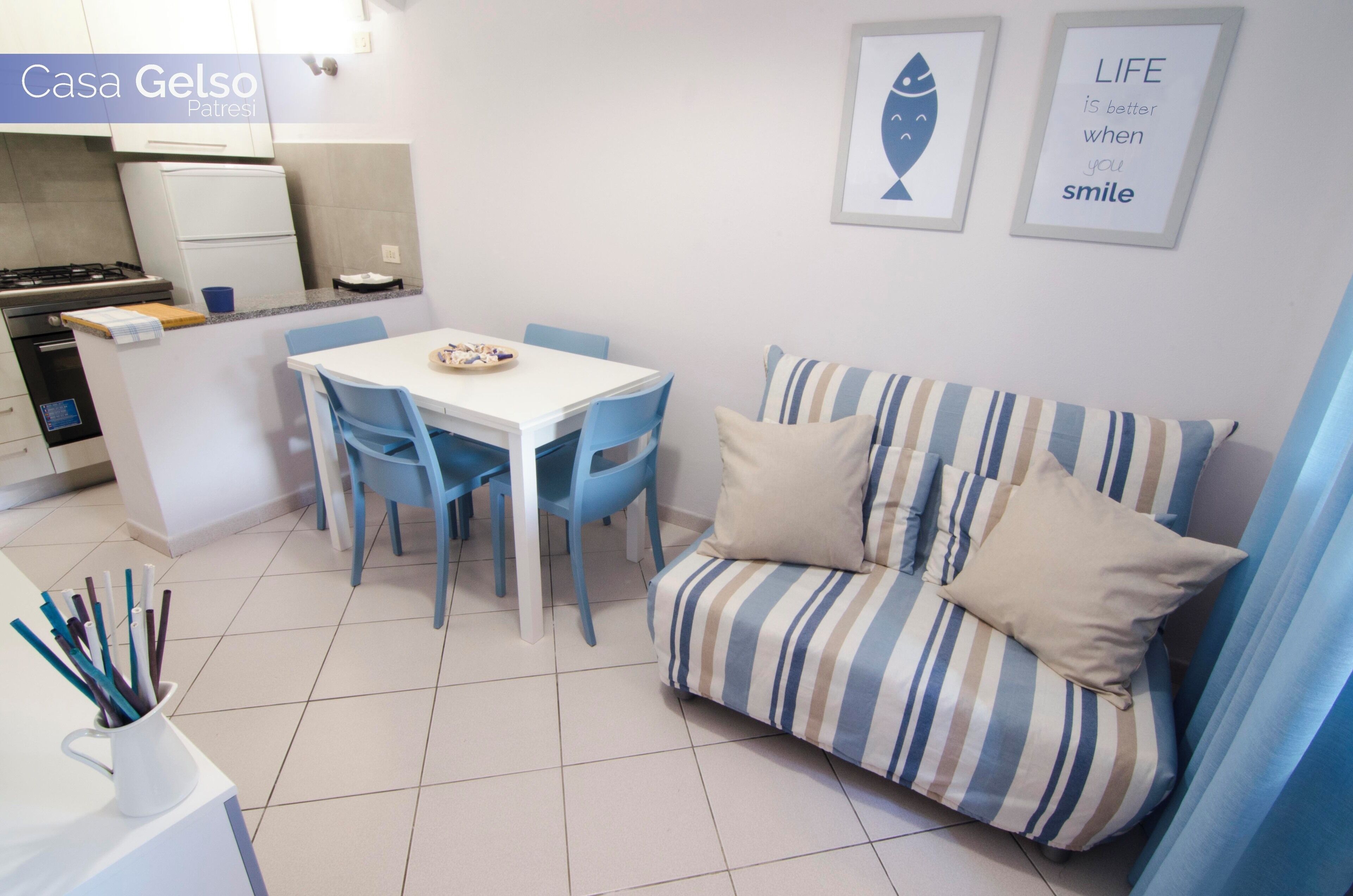 A compact living space with a kitchenette, a dining area, and a sofa.