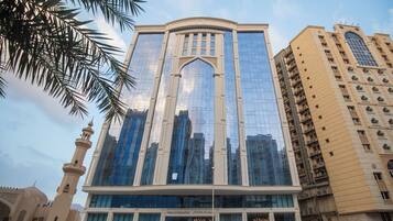 Stunning urban architecture with a central arched entrance and vertical windows.