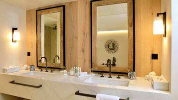 A modern bathroom with two sinks, large mirrors, and a wooden panel wall.