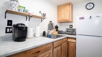 Fridge, coffee/tea maker, toaster, cookware/dishes/utensils