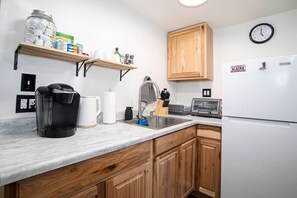 Fridge, coffee/tea maker, toaster, cookware/dishes/utensils