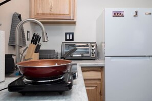 Fridge, coffee/tea maker, toaster, cookware/dishes/utensils