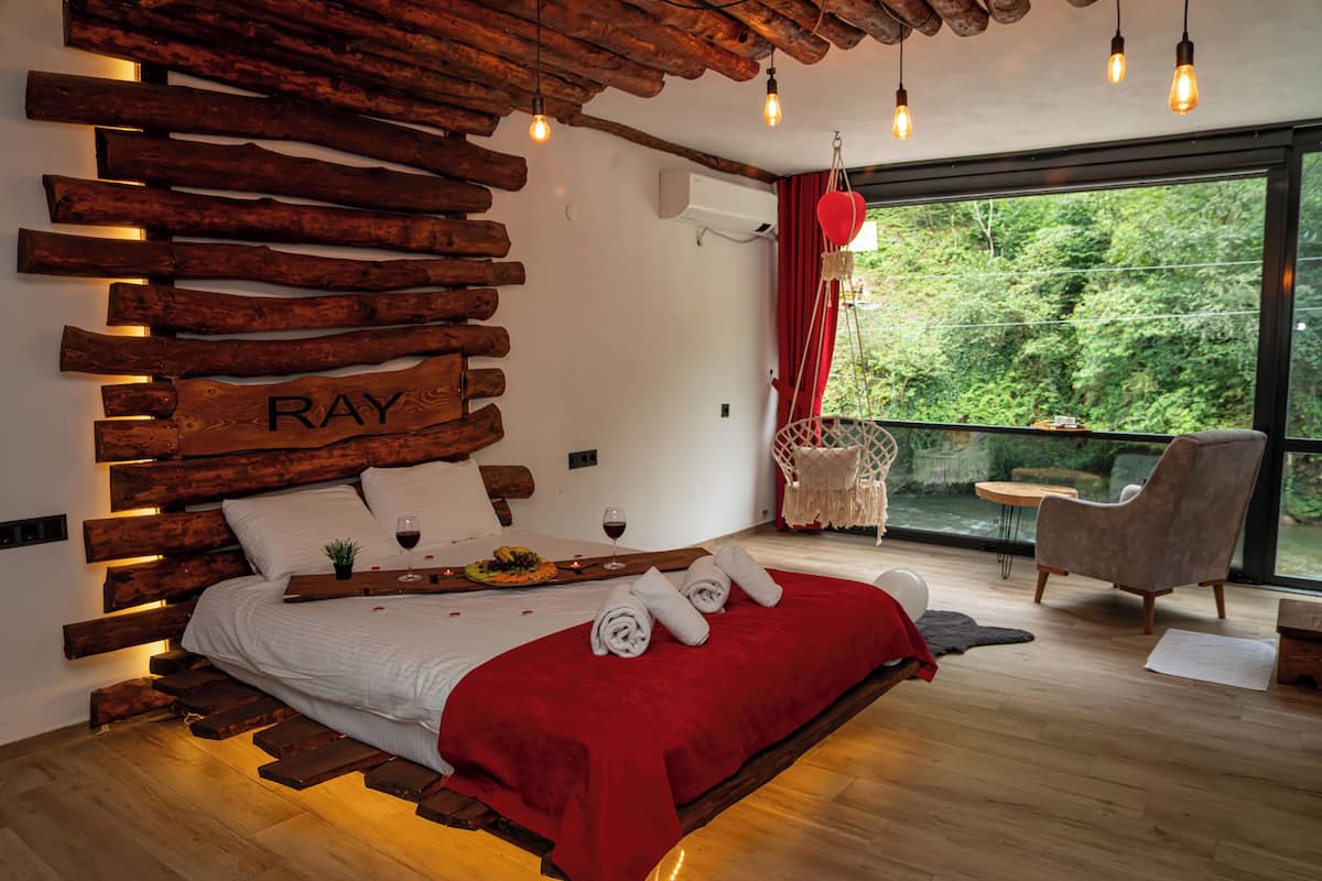 Honeymoon Suite 202, River View | Free minibar items, individually decorated, desk, blackout drapes
