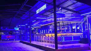 A bar with a neon sign reading "SKY TOWN" and a counter with stools. - Grand La Vogue Hotel & Casino (Sihanoukville)
