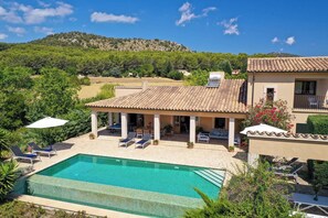A villa with a swimming pool, outdoor seating, and a view of a hill. - Finca MARA,  Pool, view, quiet location, 3 bedrooms A/C, 2 bathrooms, WIFI (IB)