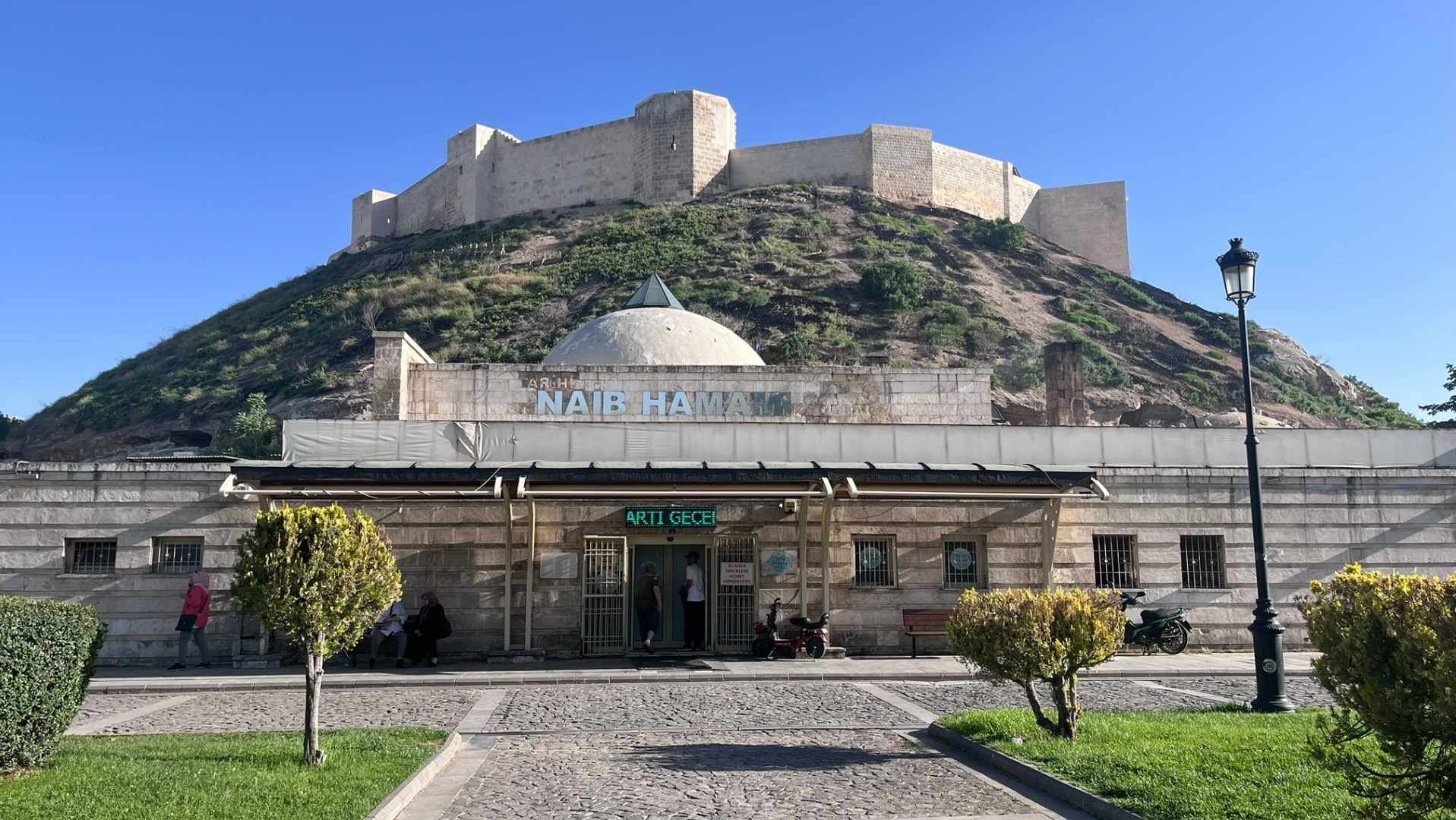 A historical building with a dome and a sign reading "NAB HAMAM".