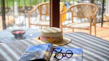 A table with a hat, glasses, and a magazine.