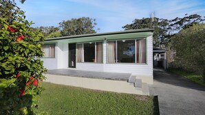 A single-story house with a flat roof, large windows, and a covered porch. - Stroll To Bennett's Beach (Hawks Nest)