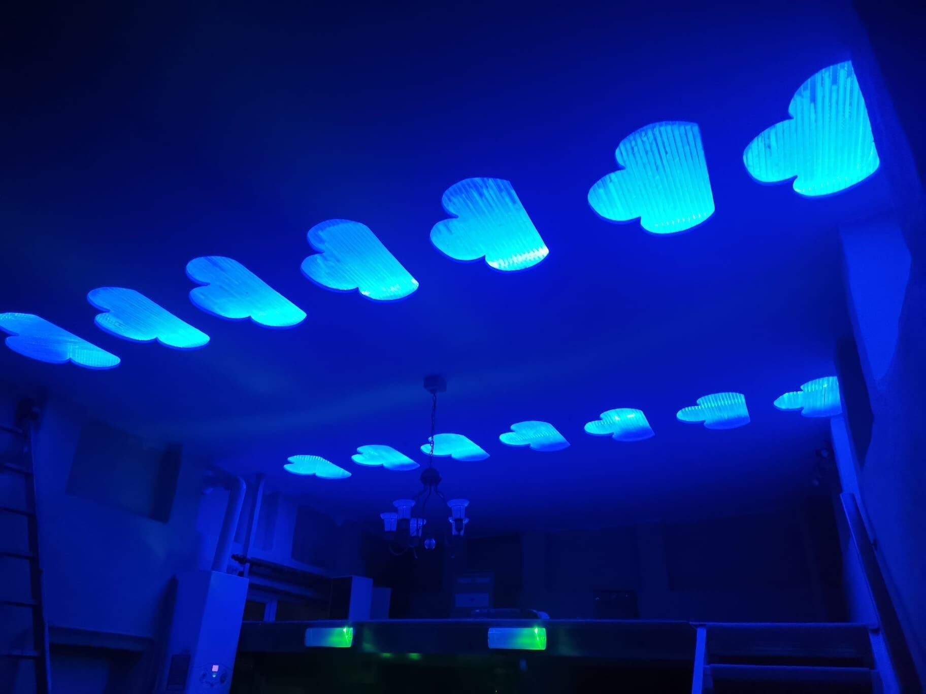 A room with a ceiling featuring heart-shaped light fixtures.