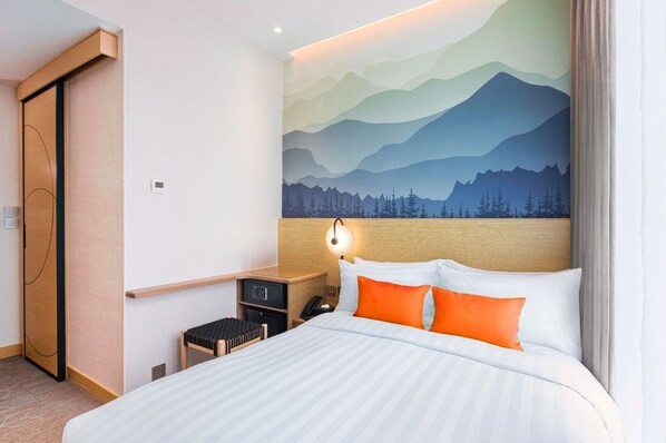 A hotel room with a bed, a nightstand, a desk, and a wall with a mountain landscape mural. - Hotel YX Lai Chi Kok (Kowloon)