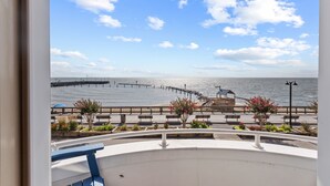 A balcony with a view of the sea, a wooden pier, and a gazebo. - Unbelievable beach views for 6 (North Beach)