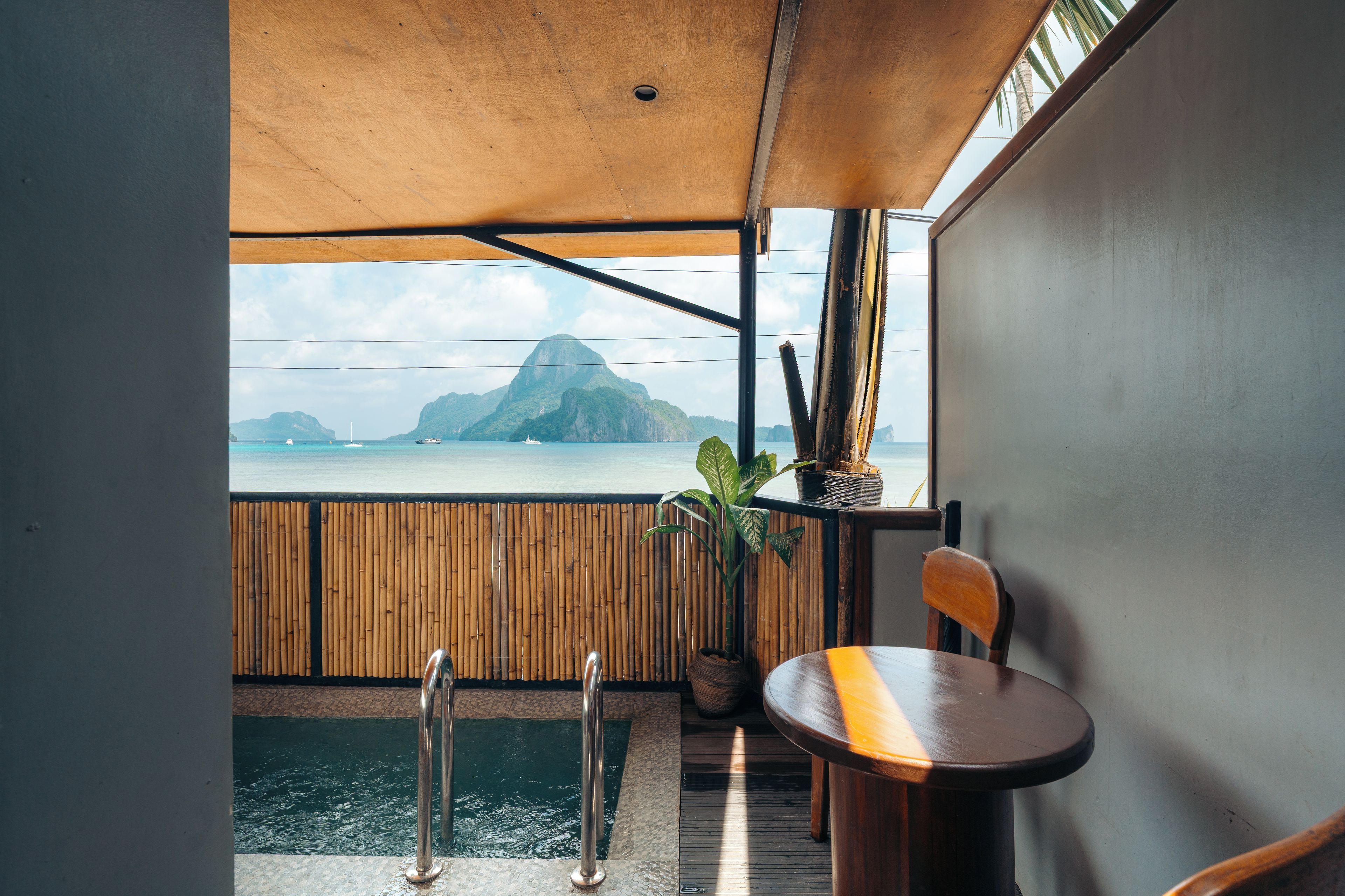 A room with a view of a body of water and a mountain.