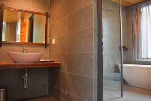 A modern bathroom with a large vessel sink, a freestanding bathtub, and a glass-enclosed shower. - Sapa Chill Retreat (Sa Pa)