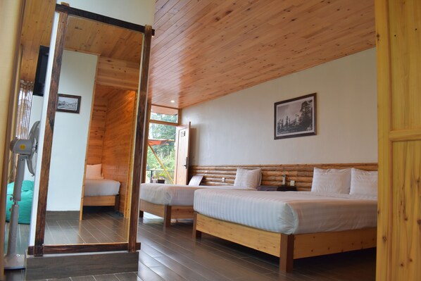 A wooden-paneled room with two beds, a large mirror, and a view of the outdoors. - Sapa Chill Retreat (Sa Pa)