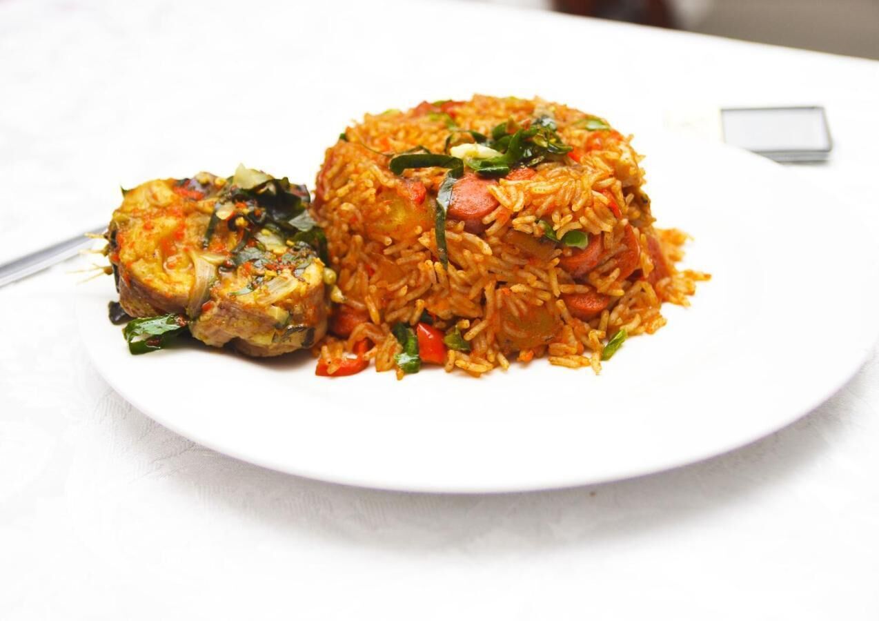 A plate of food with rice, vegetables, and a piece of meat.