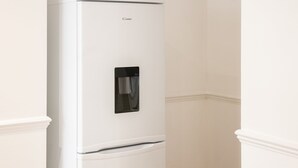 A white refrigerator with a water dispenser and a freezer compartment. - Host Stay Bardsay Road (Liverpool)