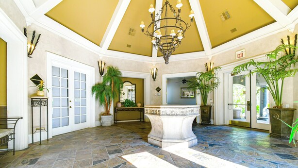 A spacious lobby with a stone floor, a central fountain, and potted plants. - 3 Mi to Tpc: Chic Condo w/ Pool Access & Grills (Scottsdale)