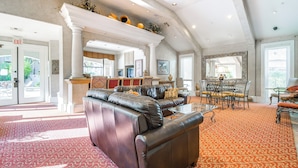A spacious lobby with a leather sofa, a dining area, and a fireplace. - 3 Mi to Tpc: Chic Condo w/ Pool Access & Grills (Scottsdale)