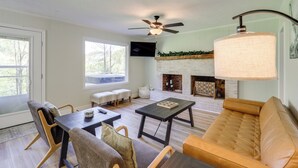 A living room with a sofa, chairs, a coffee table, a fireplace, and a ceiling fan. - 24 Private Acres: Trails/hot Tub Near Blowing Rock (Lenoir)