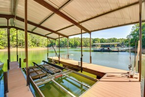 A covered dock area with a view of a lake and forest. - Waterfront Hartwell Apartment w/ Dock Access! (Hartwell)
