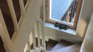 A wooden staircase with a window at the top.