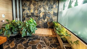 A spa area with a stone wall, wooden floor, and potted plants. - Casita 2 Beautiful Cabin - Stunning View (Filandia)