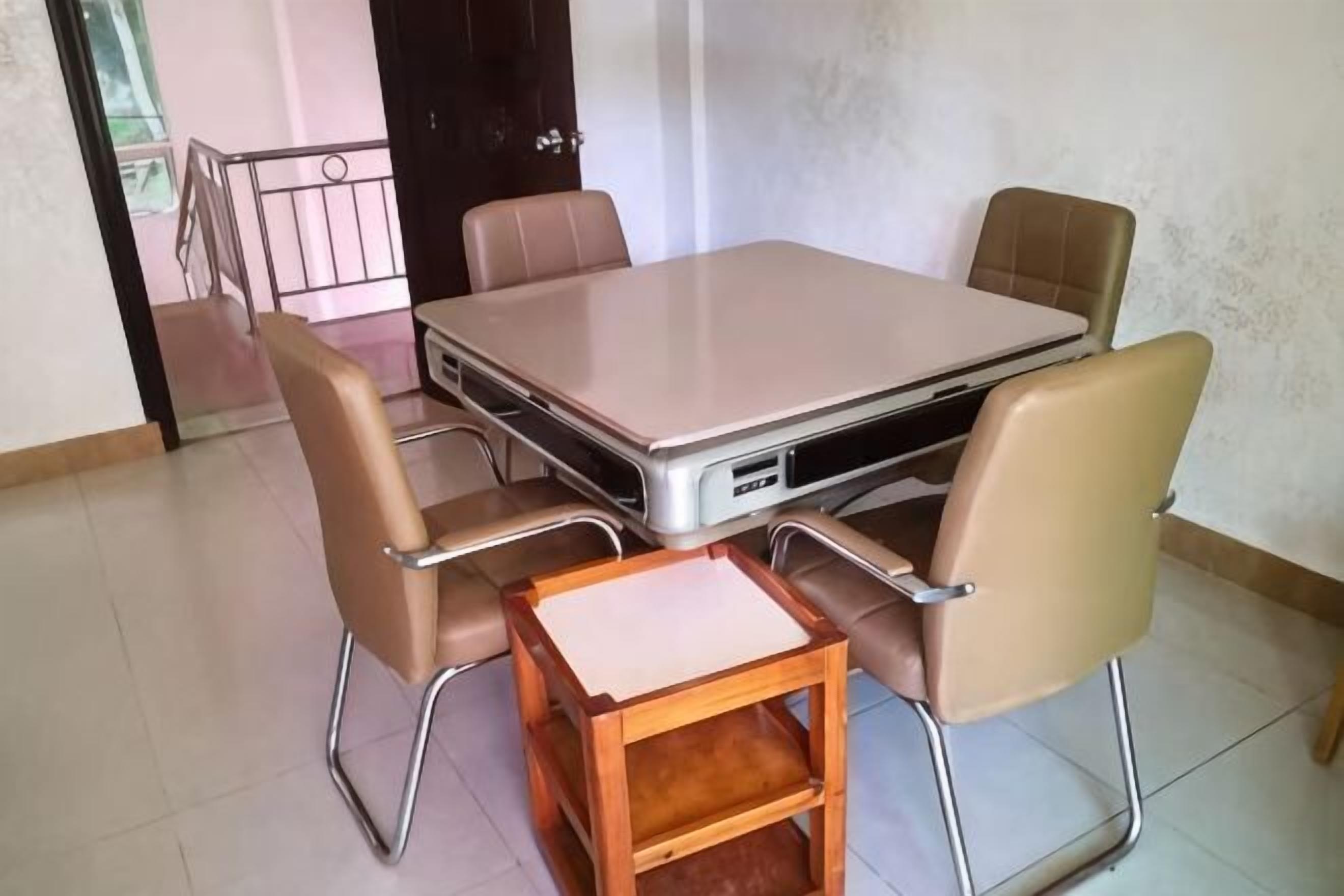 A conference room with a large table and four chairs.