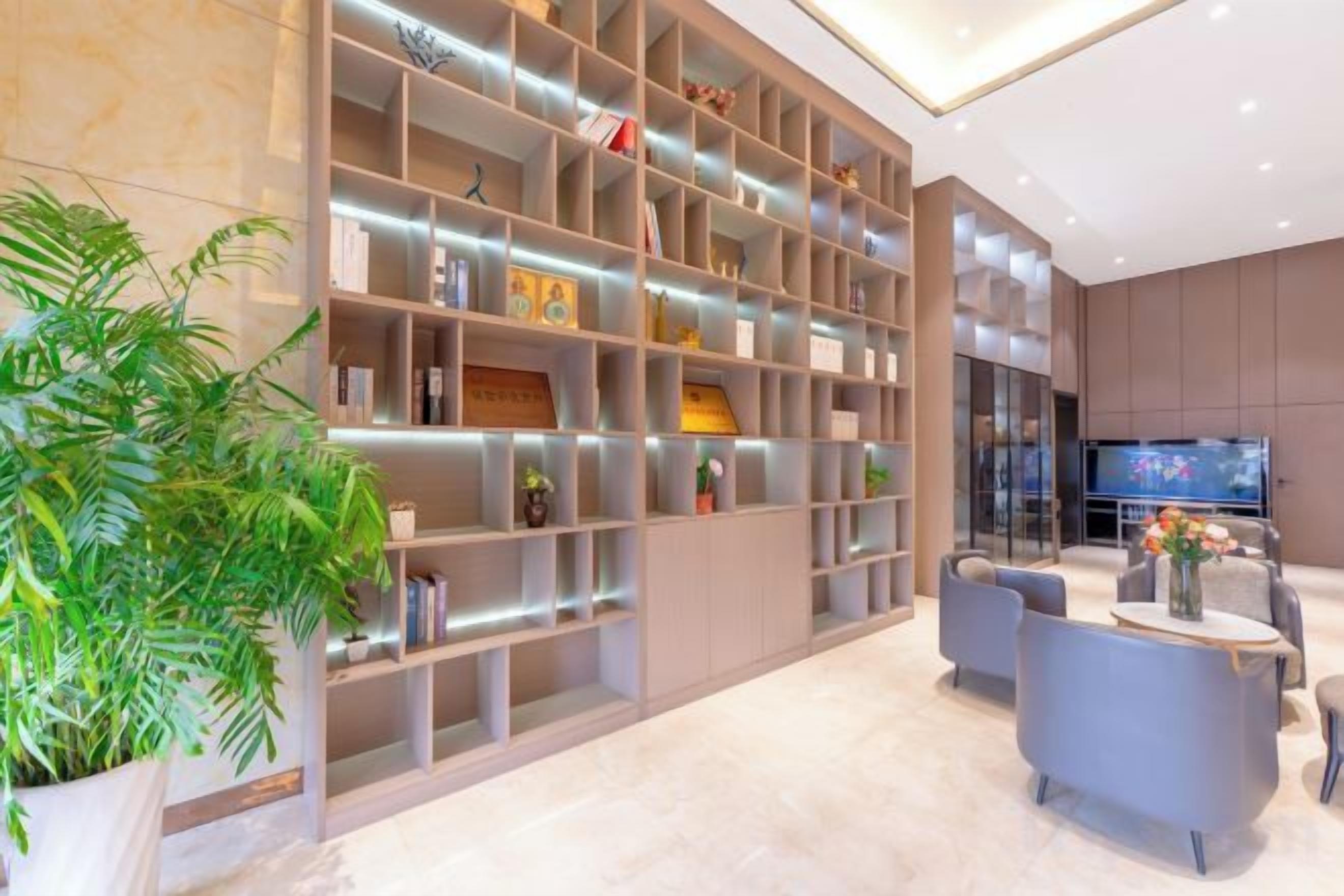 A modern interior with a large shelving unit, seating area, and a television.