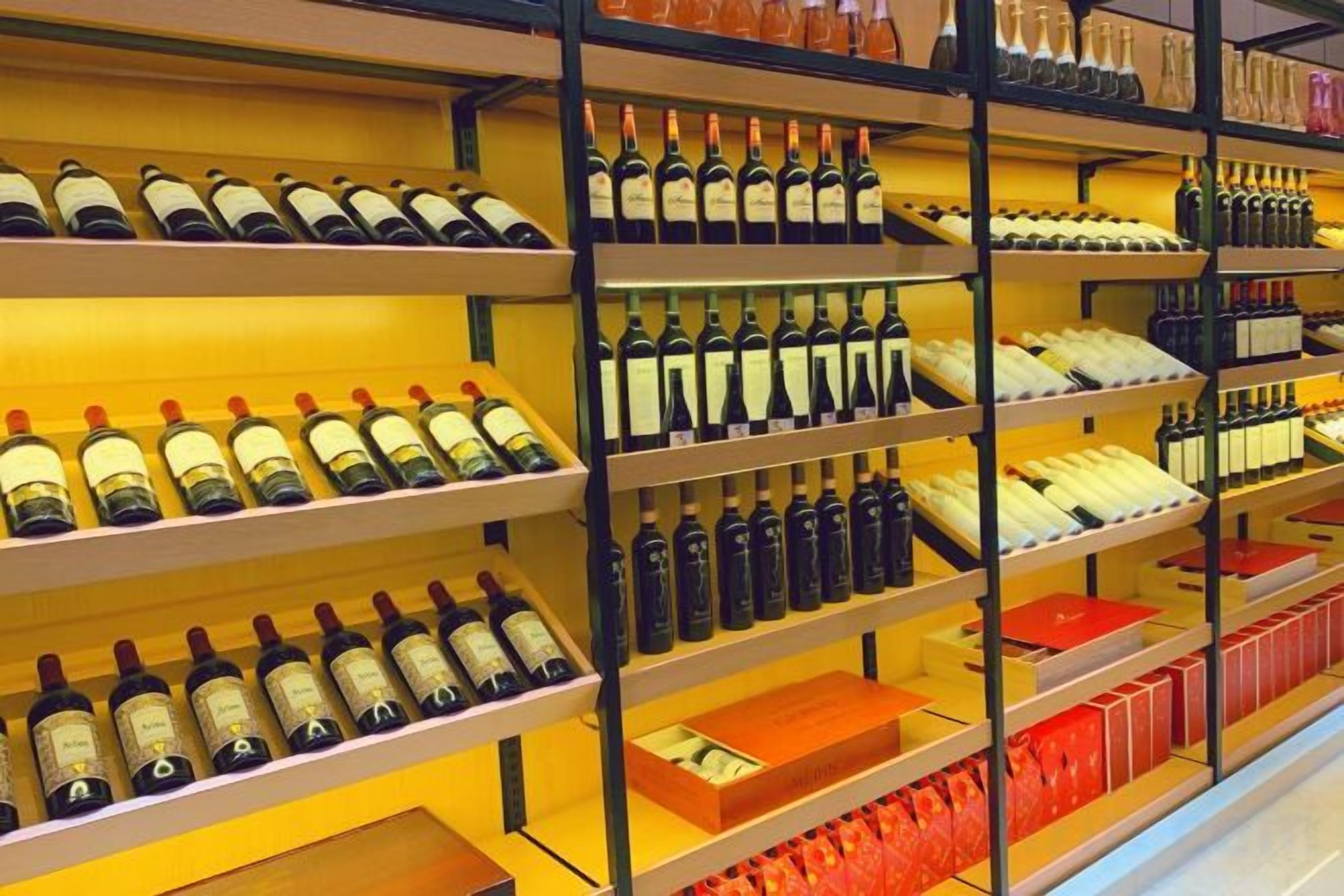Shelves stocked with wine bottles in a store.