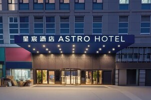 The exterior of the Astro Hotel with a prominent entrance and a sign above the doors.