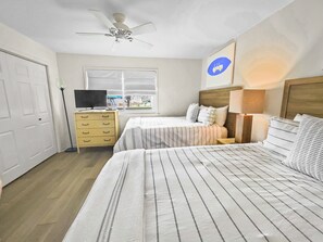 Relax in this cozy space with a large bed, bedside table, and TV.