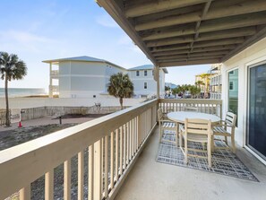 Enjoy stunning ocean views from this balcony with a table and chairs.