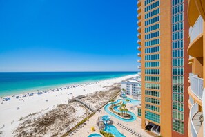 A high-rise hotel with a beach view, a pool area, and a boardwalk. - Phoenix Gulf Towers 808 4 Bedroom Condo (Orange Beach)