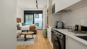 A modern apartment with a kitchen, a dining area, and a living room. - The Sage l Studio l New Development (Cape Town)