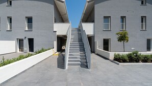 A symmetrical building with a central staircase leading to an upper level. - Lolita's Beachfront Loft by Wonderful Italy (Bari)
