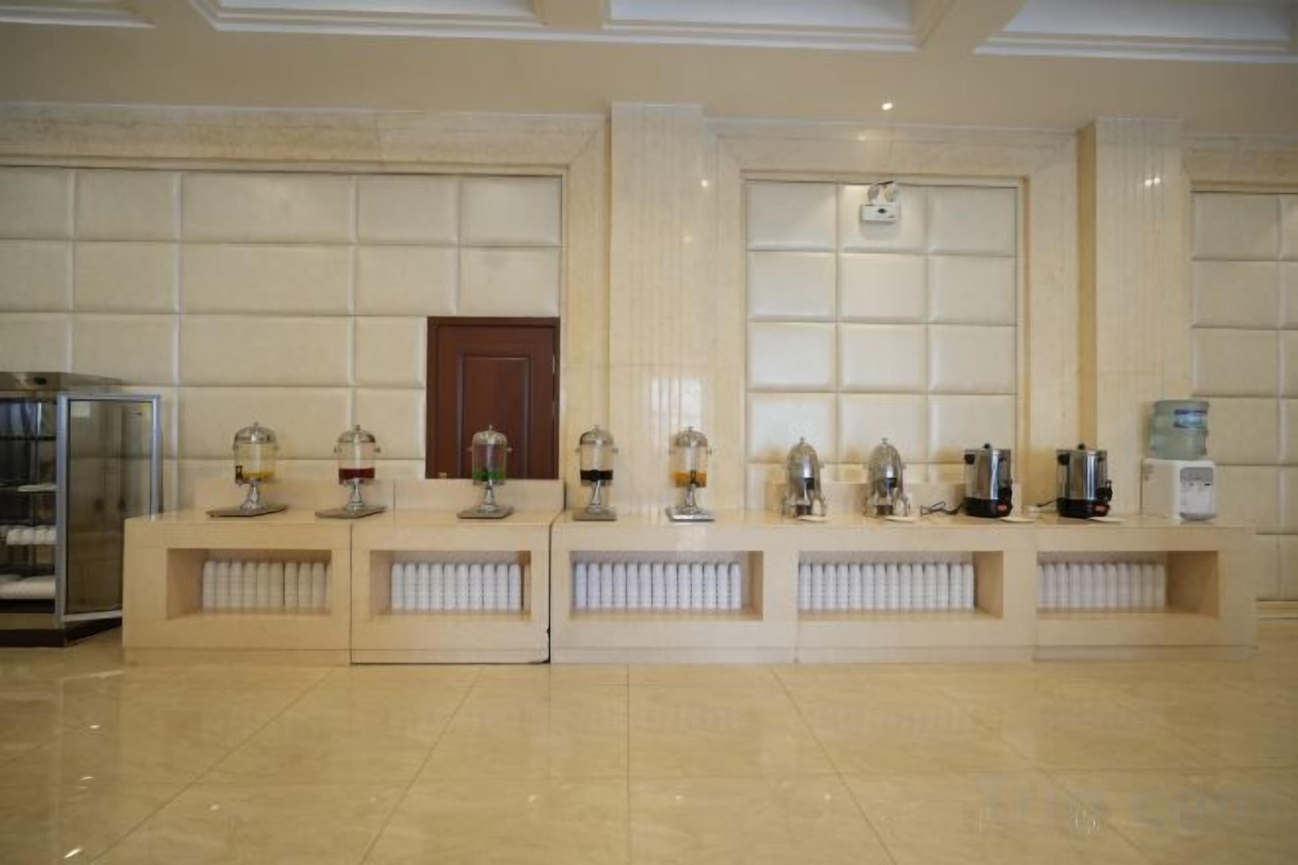 A reception area with a reception desk, a water dispenser, and a coffee machine.