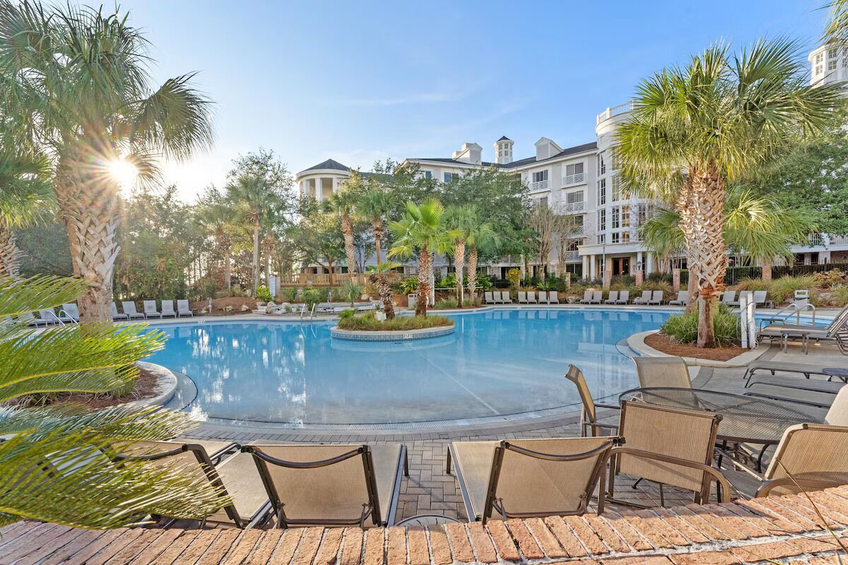 Unwind at this resort-style pool surrounded by palm trees, sunlit water, and laid-back coastal vibes—perfect for relaxing afternoons and warm Florida days.
