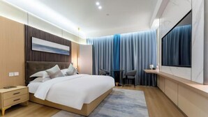 A modern hotel room with a large bed, bedside tables, a small desk, and a TV. - Ningbo jinfu hotel apartment (Ningbo)