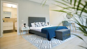 A modern bedroom with a bed, bedside tables, a nightstand, a small round mirror, and a potted plant. - Hilltop Villa with Breathtaking Mountain Views - Sauna & Pool  (Zărnești)