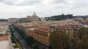 A cityscape with historic architecture, including a prominent dome and a tower. - TERRAZZA SAN PIETRO EXCLUSIVE APARTMENT DE LUXE IN ROME  (Roma)