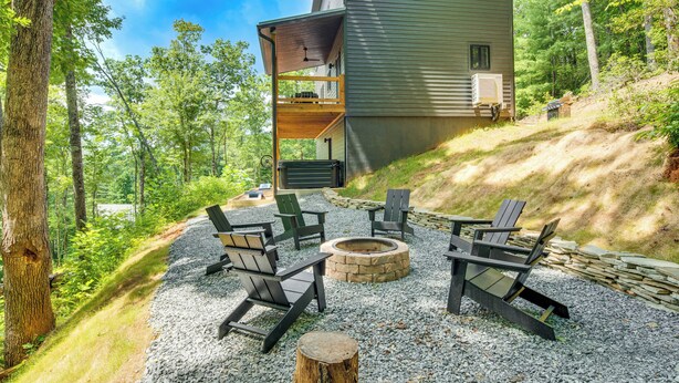 A cabin with a deck, outdoor seating, and a fire pit. - Modern Hiker's Haven w/ DuPont State Forest Views! (Hendersonville)