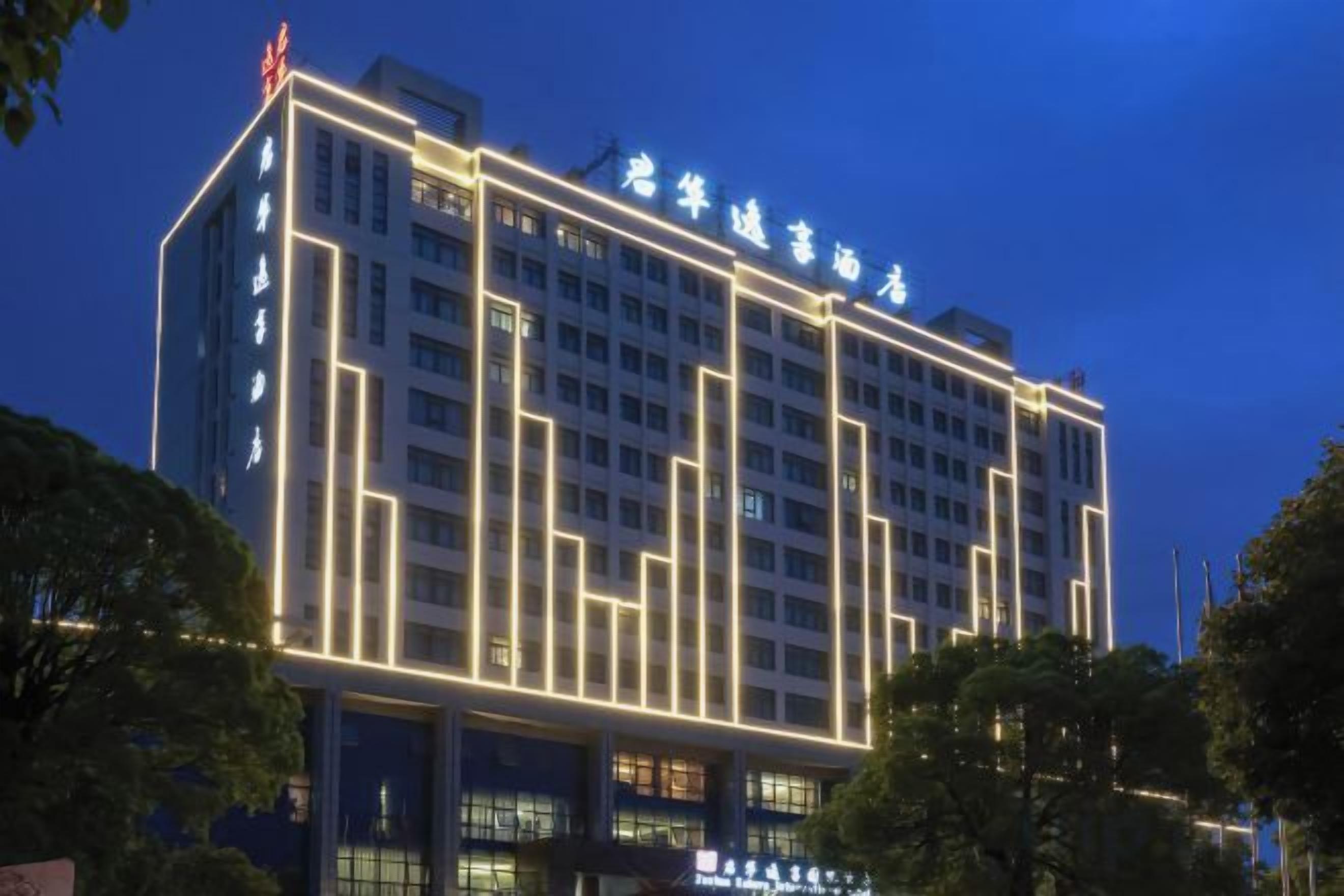 A multi-story hotel with illuminated signage and a modern architectural design.