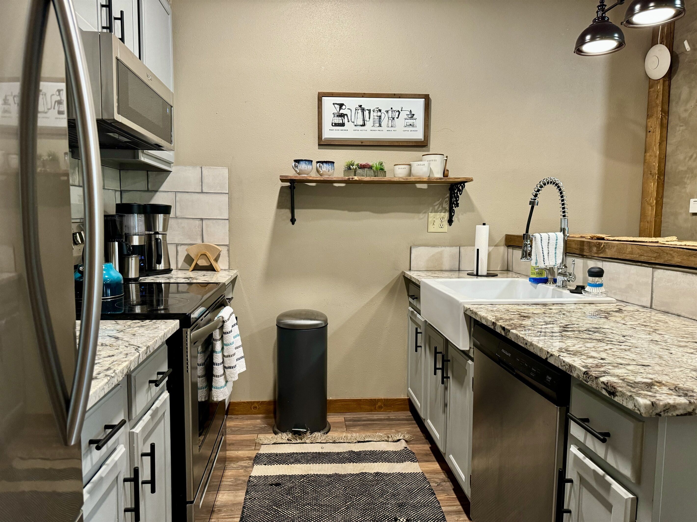 A compact kitchen with a refrigerator, coffee maker, and sink.