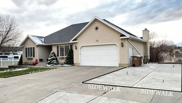 A single-story house with a garage, a driveway, and a sidewalk. - Cozy Private Suite with Kitchen, Gym, and More in UT! (Draper)