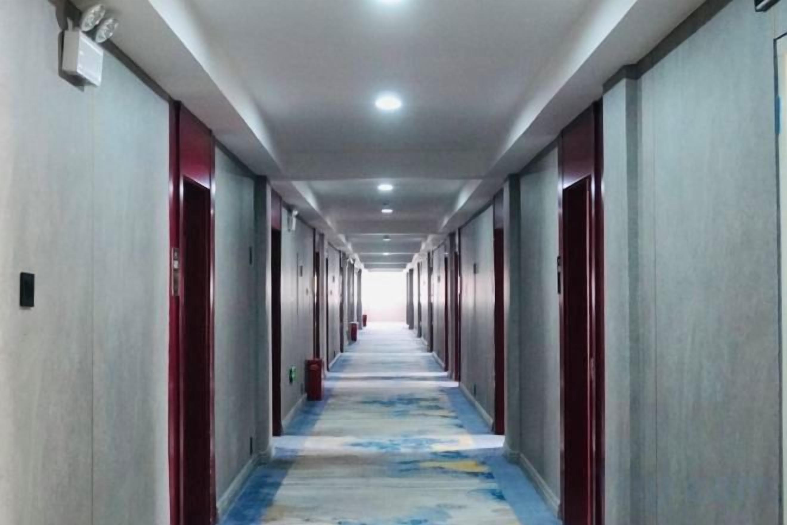 A long corridor with doors on both sides, leading to individual rooms.
